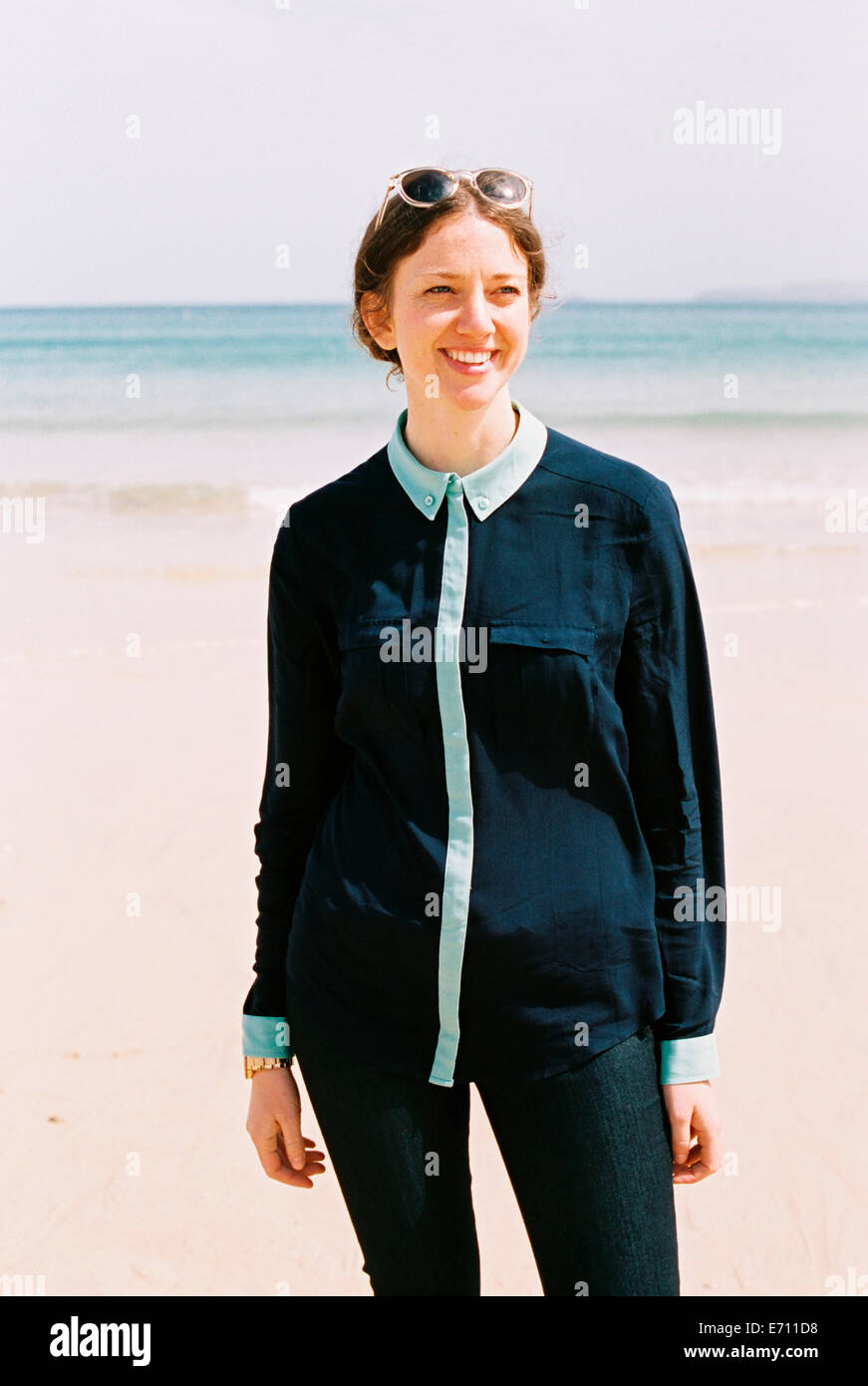 A woman standing on a beach with her back to the ocean Stock Photo - Alamy