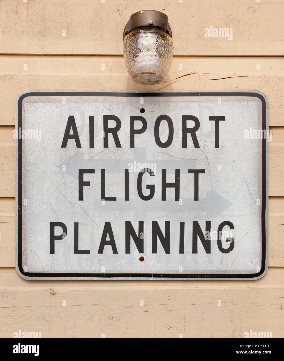 Old airport flight planning sign on exterior wooden wall. Stock Photo