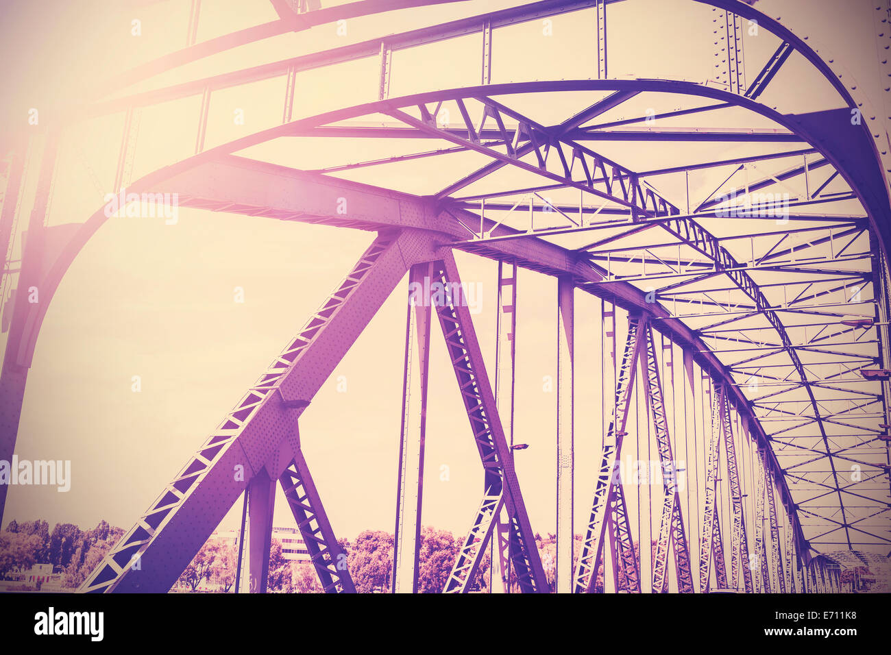 Vintage stylized photo of a steel bridge with sun light. Stock Photo