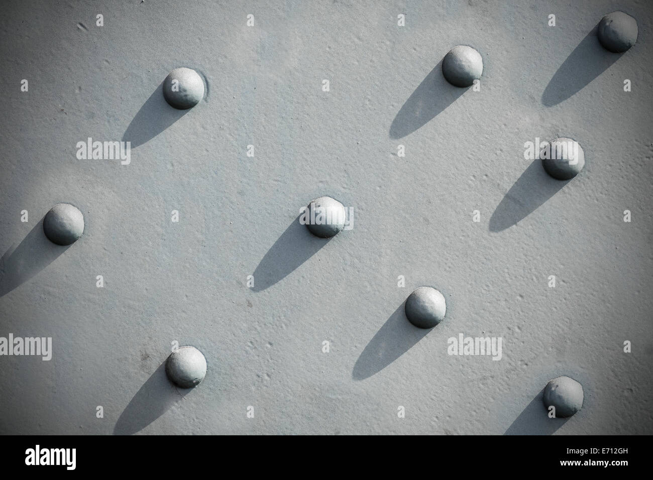 Abstract gray background, riveted metal textured. Stock Photo
