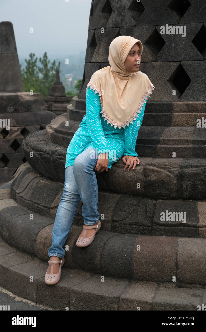 Borobudur, Java, Indonesia.  Young Indonesian Woman Combining Islamic and Western Dress Styles--Levis and a Headscarf. Stock Photo