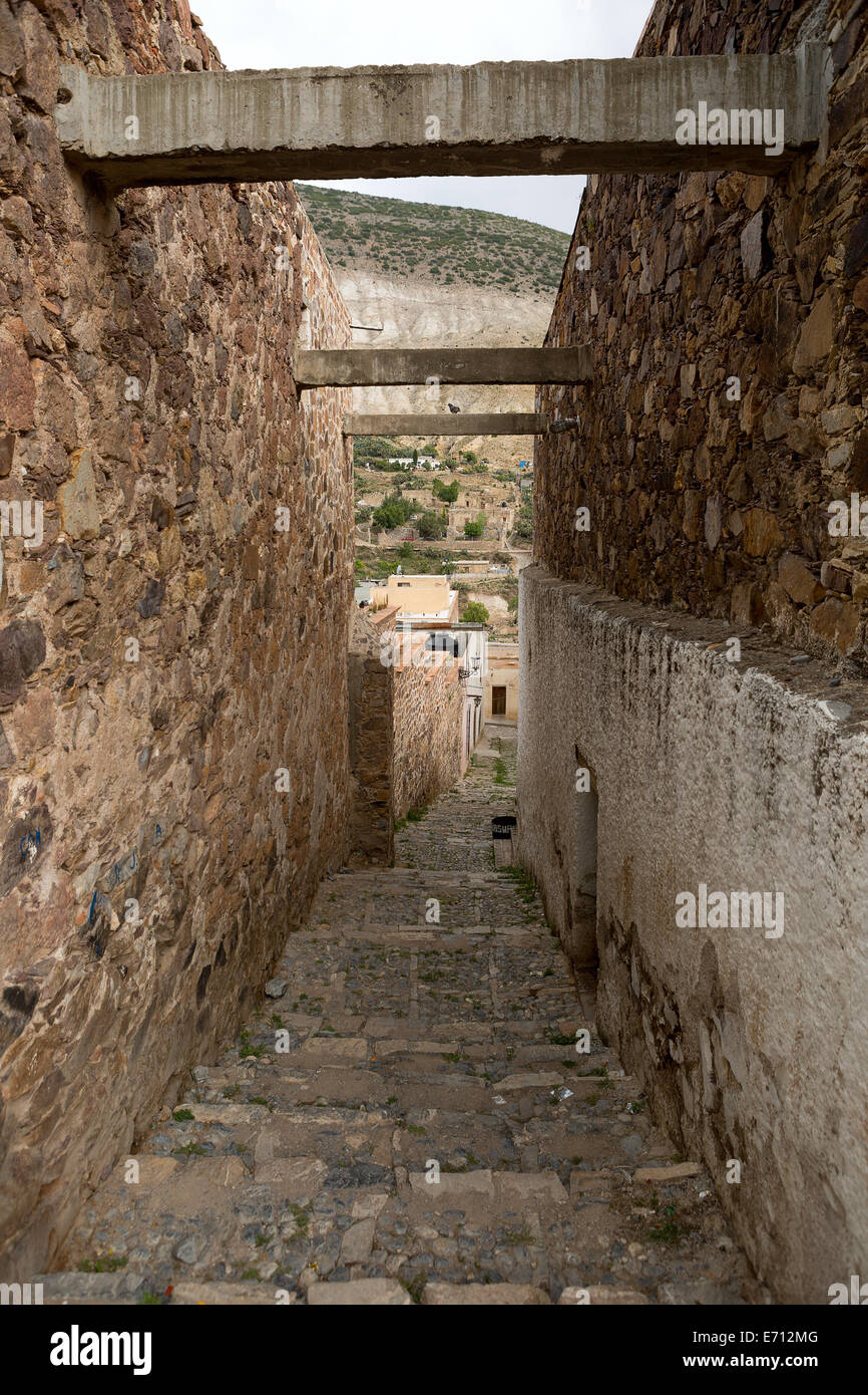 Narrow descending stone street in Real de Catorce Mexico Stock Photo