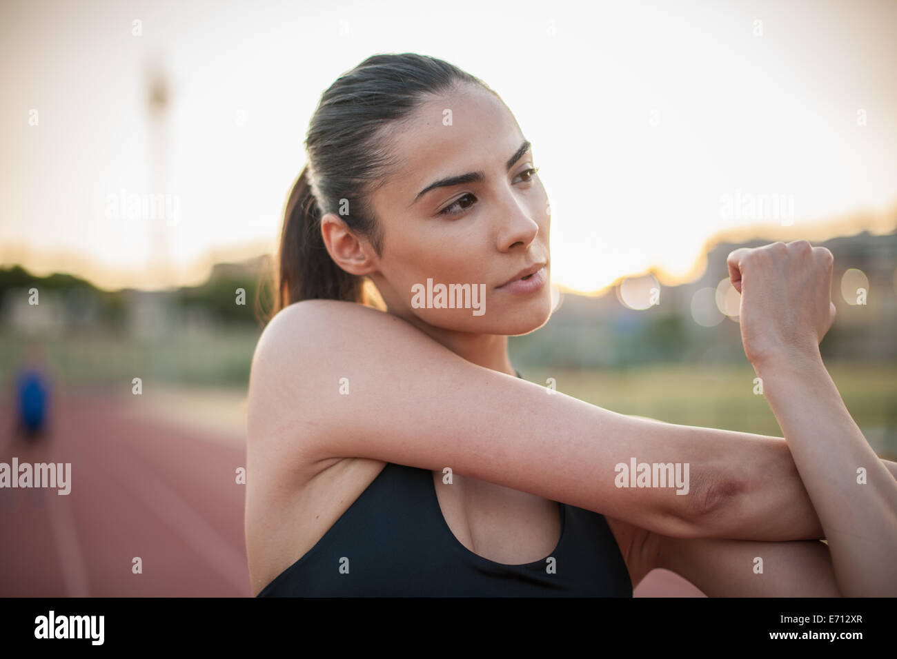 Young woman stretching arm Stock Photo