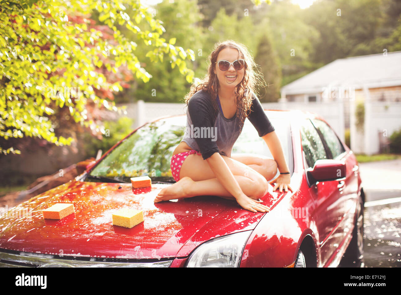 Young woman sitting on car portrait Stock Photo Alamy