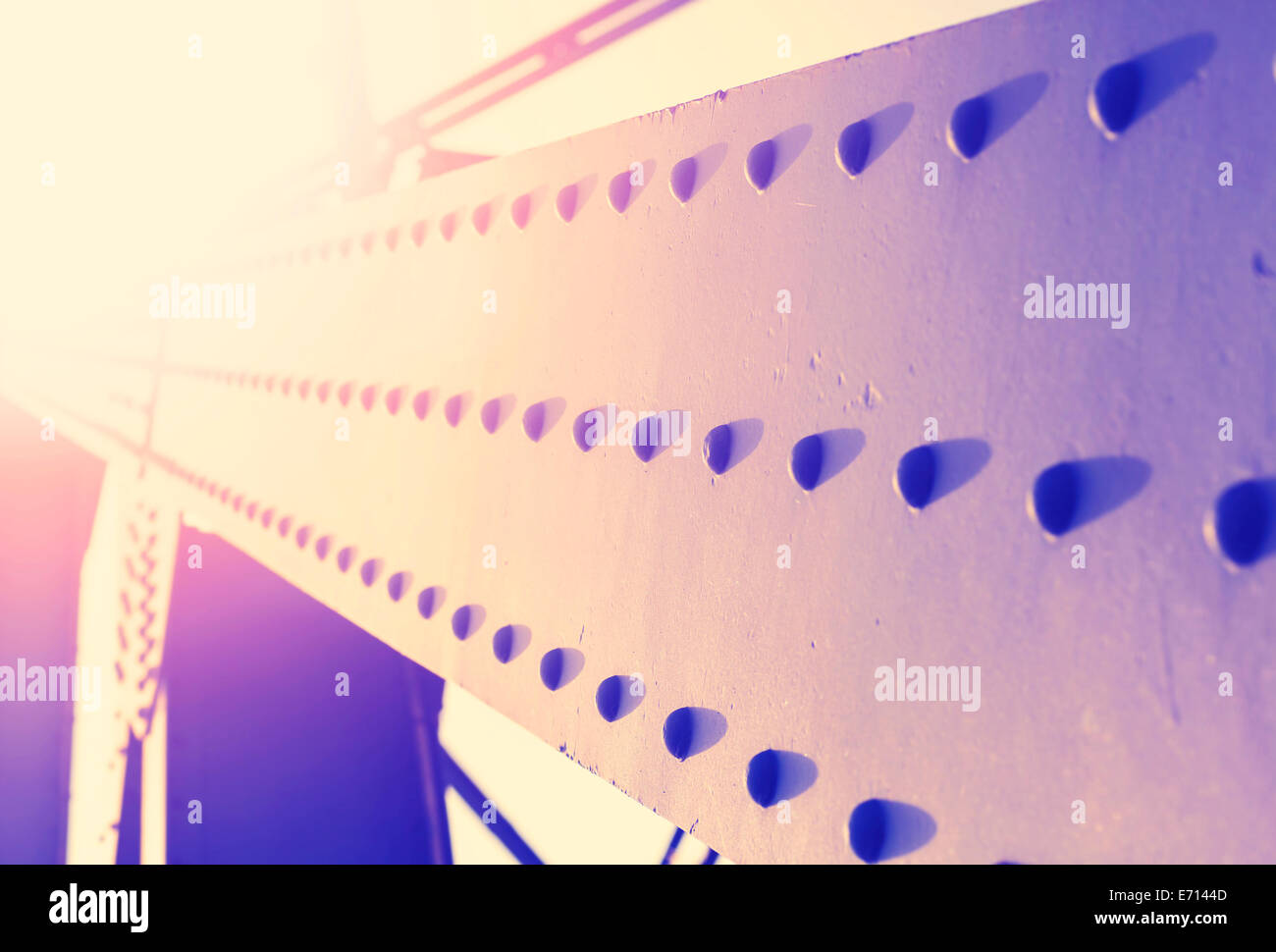 Vintage colorful abstract background of steel construction with rivets, shallow depth of field. Stock Photo