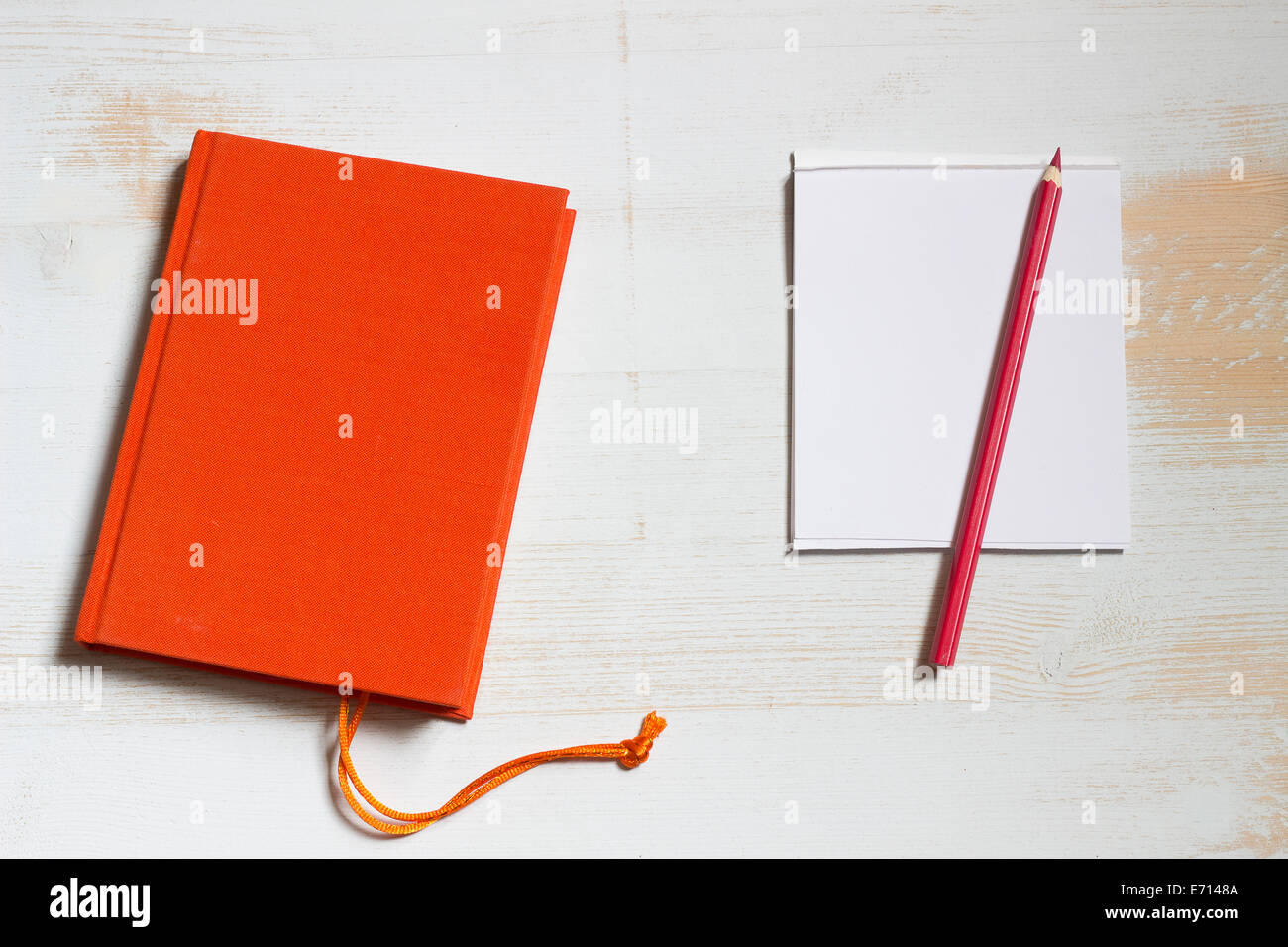 Red book and notepad with coloured pencil Stock Photo