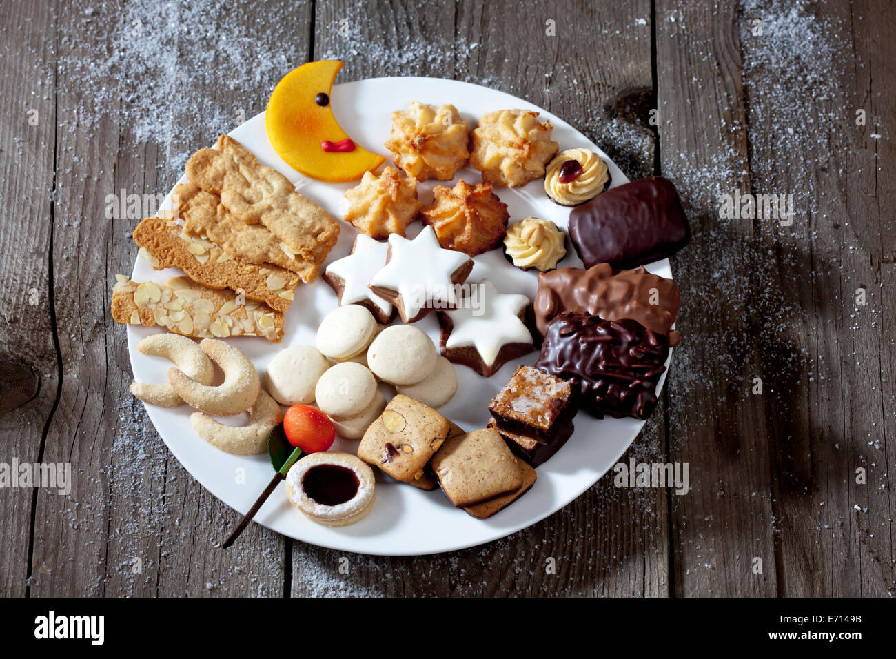 Plate of different Christmas cookies on grey wood Stock Photo