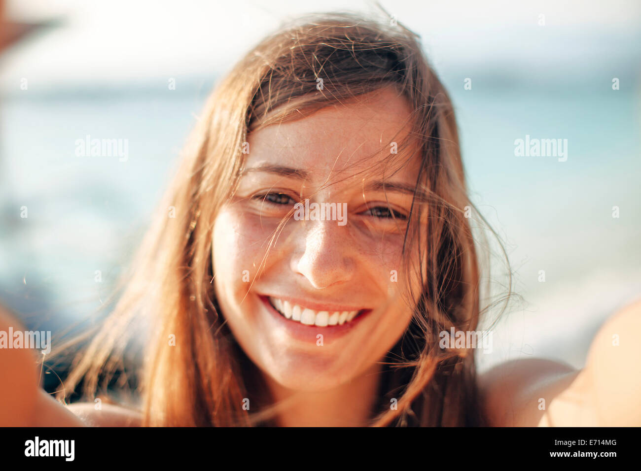 Indonesia, Gili Islands, portrait of happy woman on the beach Stock Photo