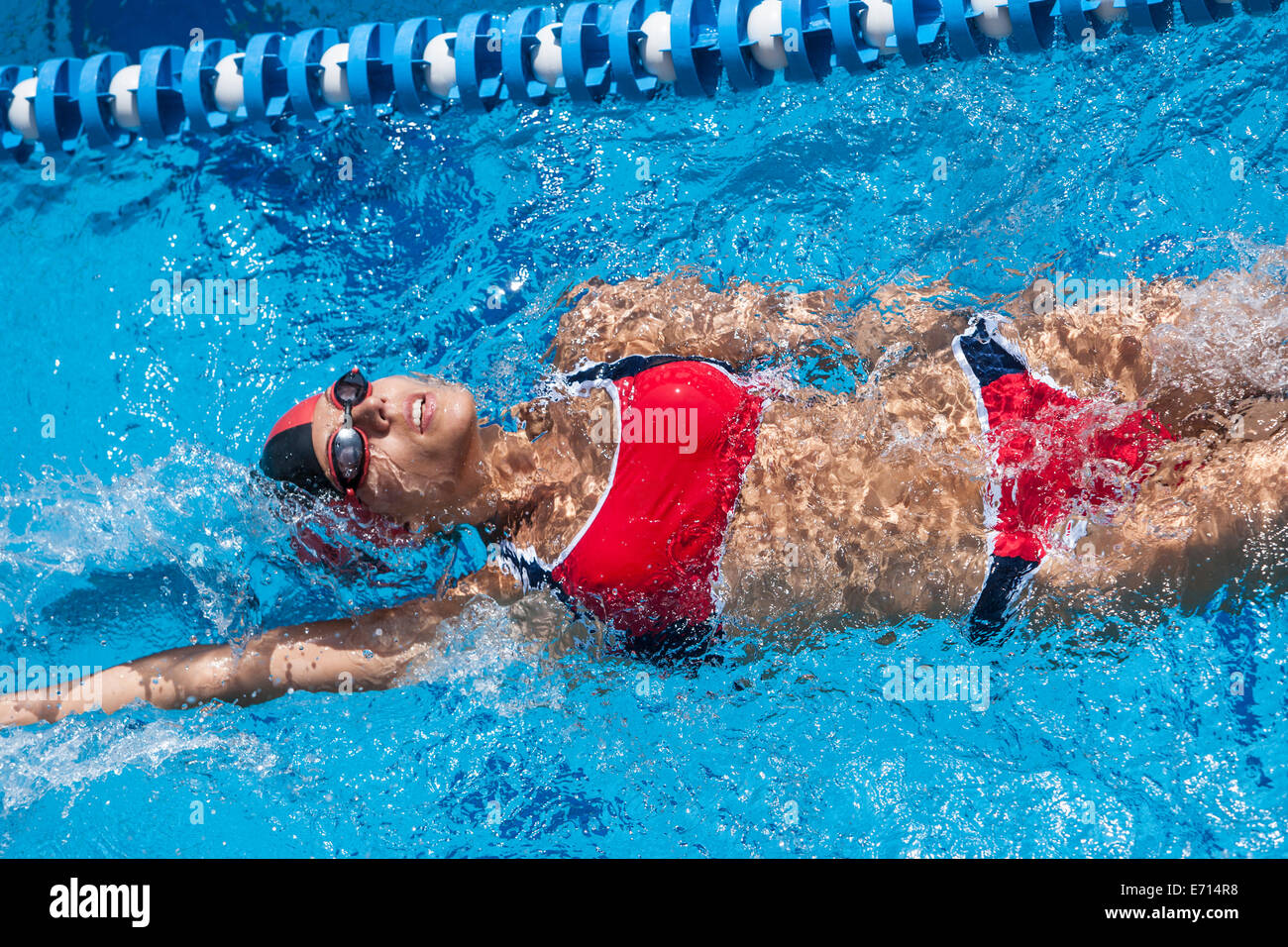 Woman with red bikini swimming in pool Stock Photo - Alamy