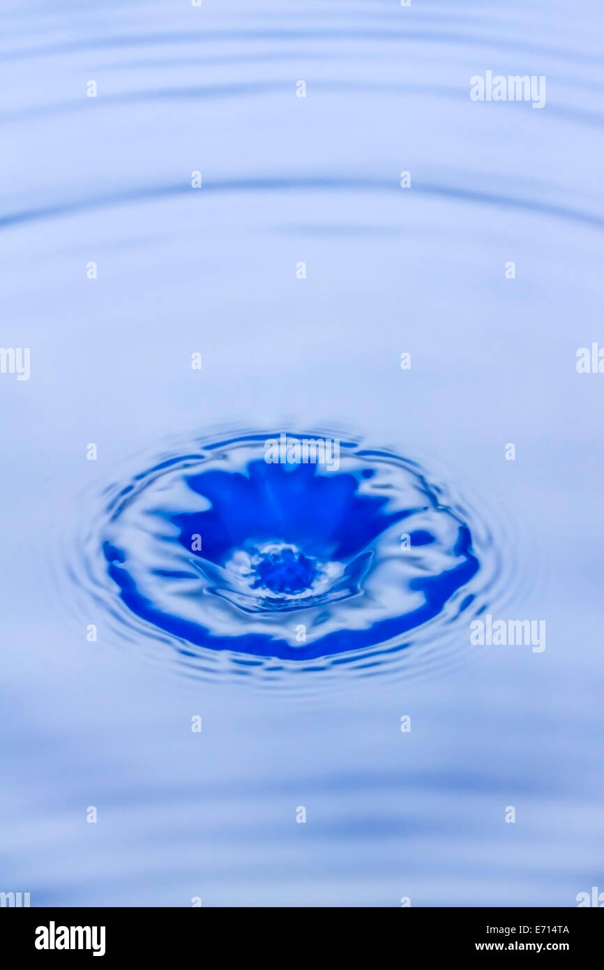 Waterdrop splashing in water Stock Photo