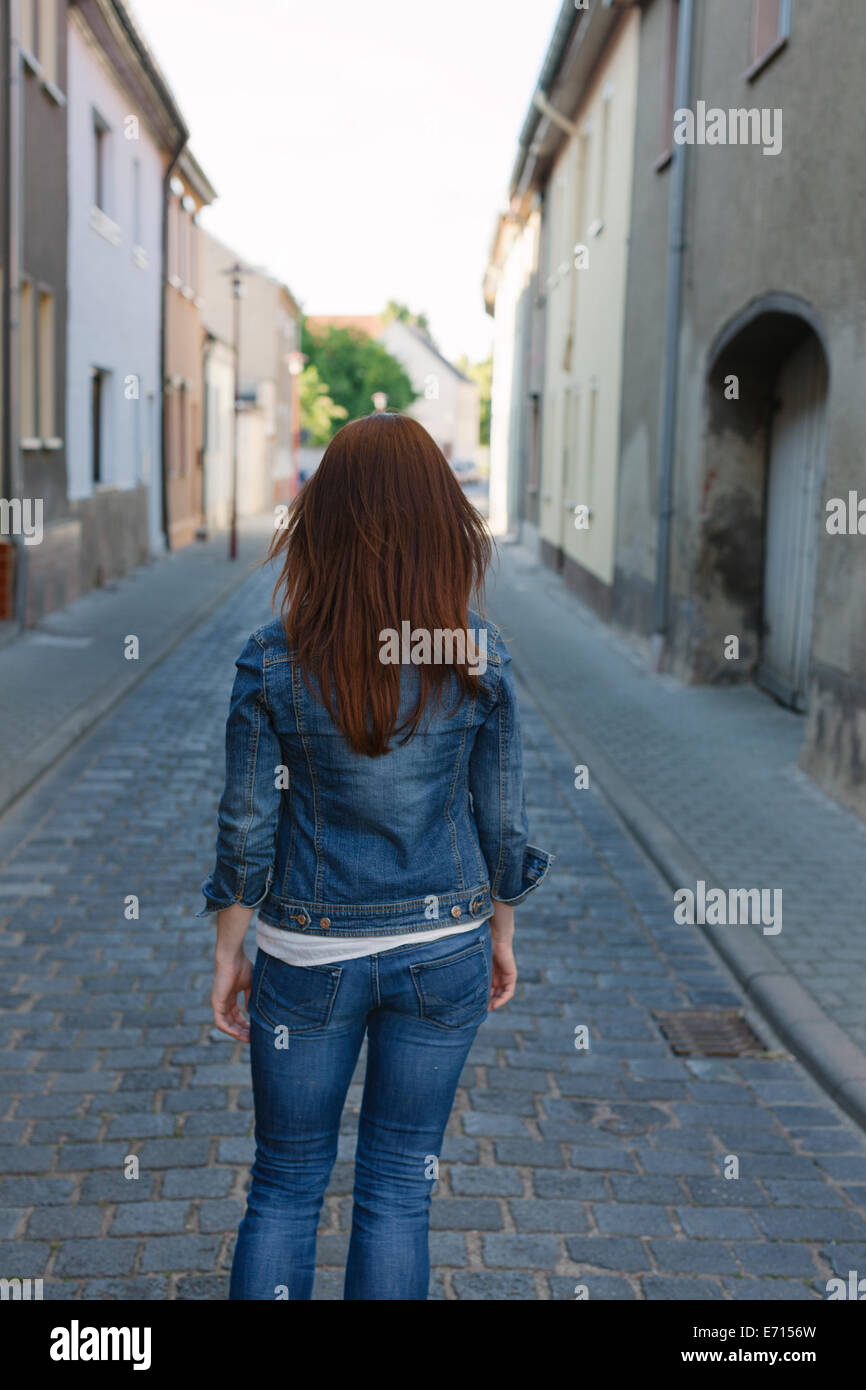 Rear view of brunette woman in a street Stock Photo - Alamy