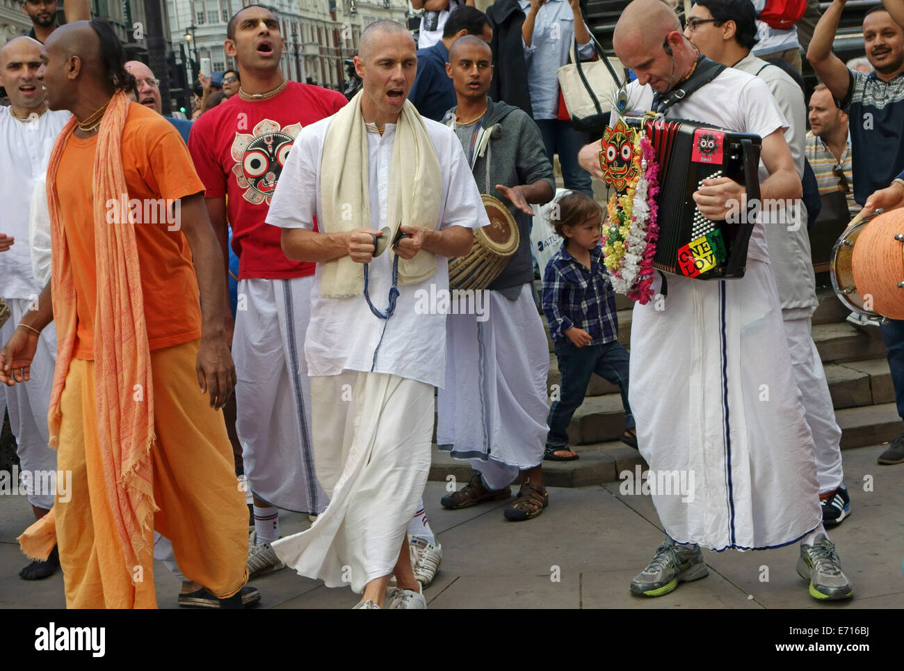 Hare Krishna followers performing in Piccadilly Circus, London Stock Photo