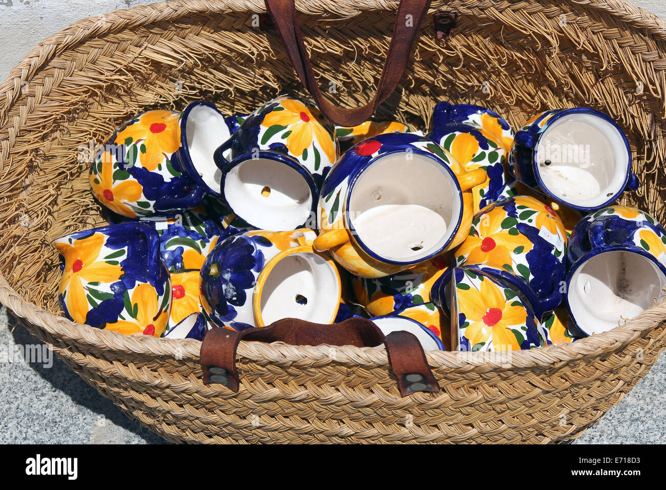 Traditional spanish ceramic jugs in rattan basket Stock Photo Alamy