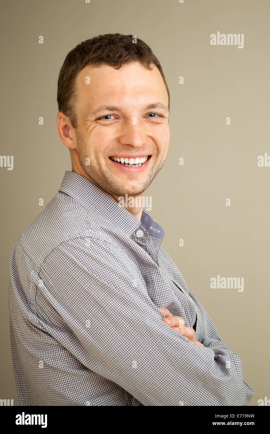 Young Caucasian man laughs, casual studio portrait Stock Photo