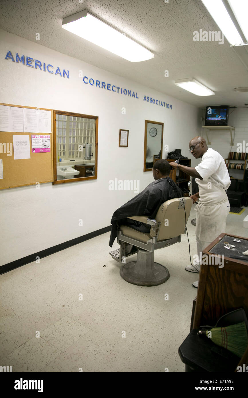 Inmate cuts hair of fellow prisoner at the barber shop inside Darrington Prison, a correctional institution near Houston, Texas Stock Photo