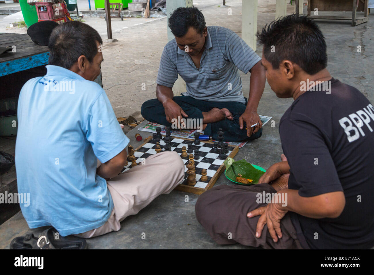 Yogyakarta, Java, Indonesia.  Men Playing Chess in the Prambanan Temple Compound. Stock Photo