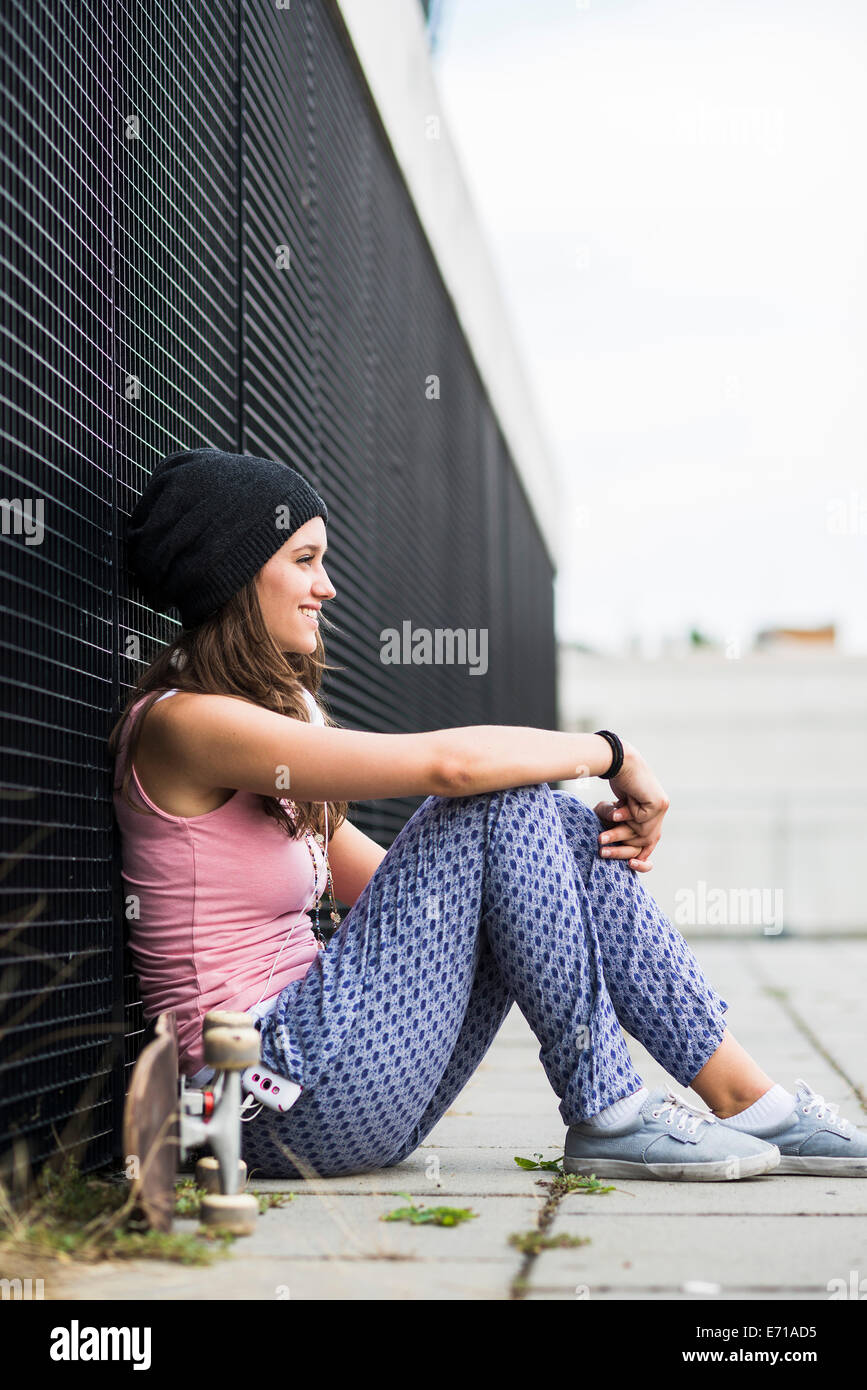 Girl sitting knees up smiling hi-res stock photography and images - Alamy