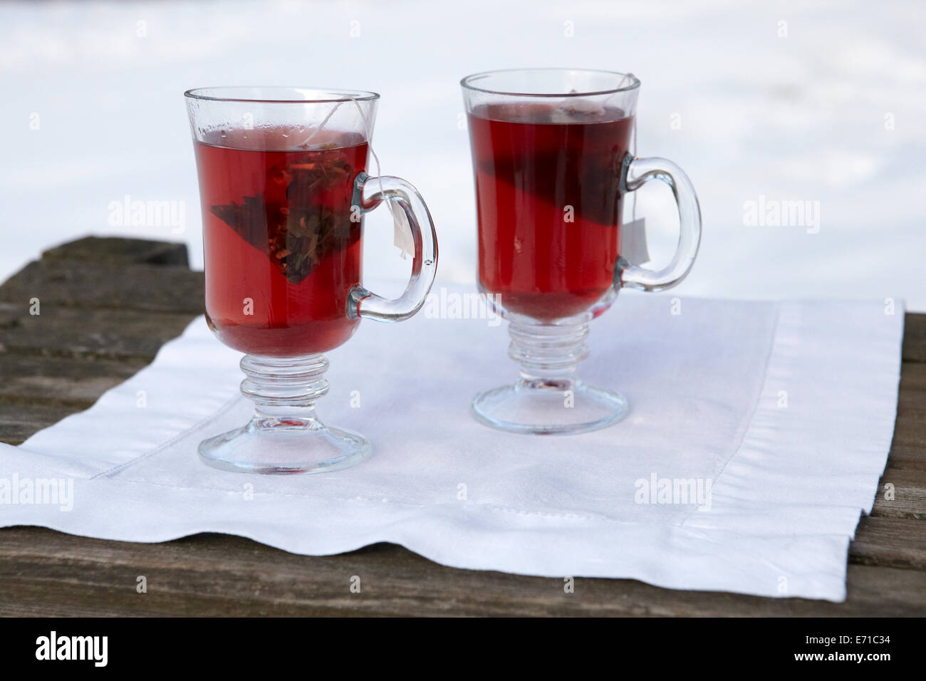 Hot herb tea in outdoor snowy winter setting Stock Photo