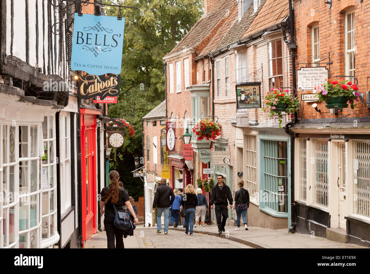 People walking on Steep Hill, an ancient street in Lincoln, England UK Stock Photo