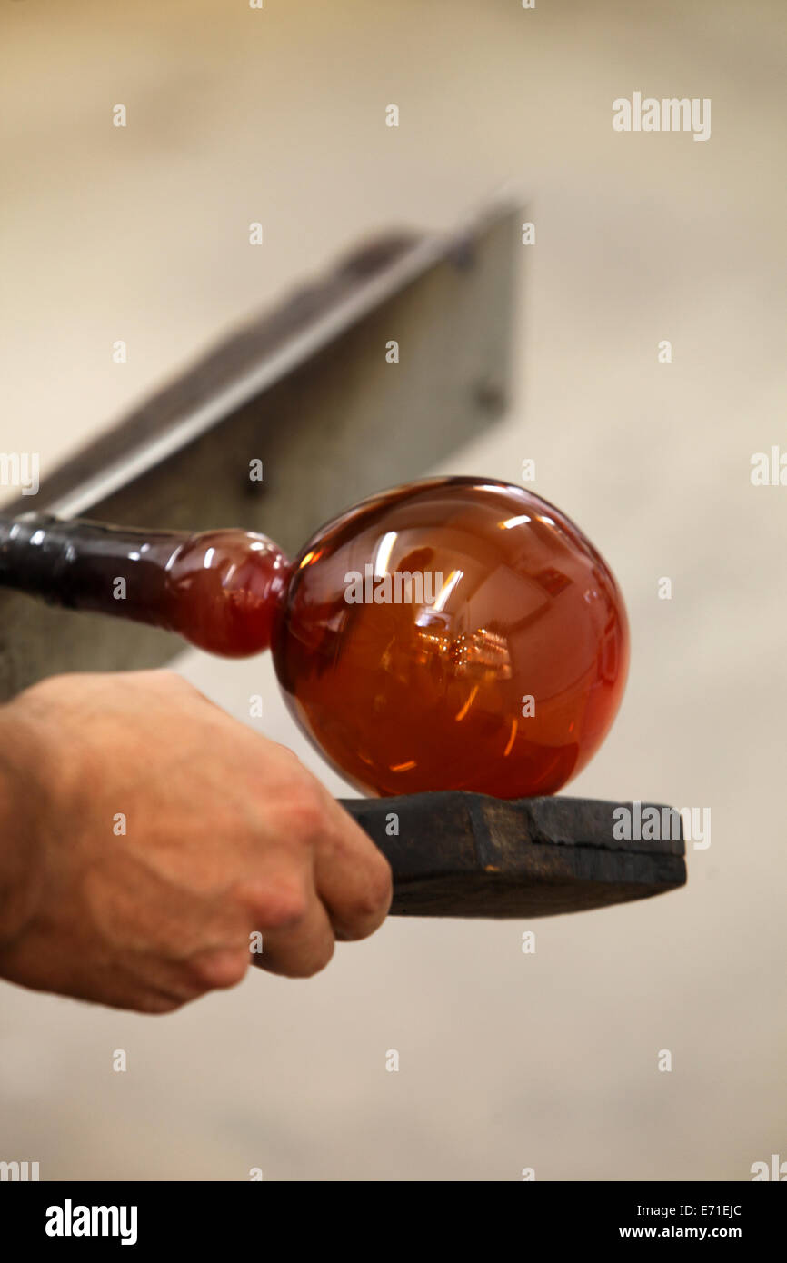 turning and shaping molten glass into a vase Stock Photo