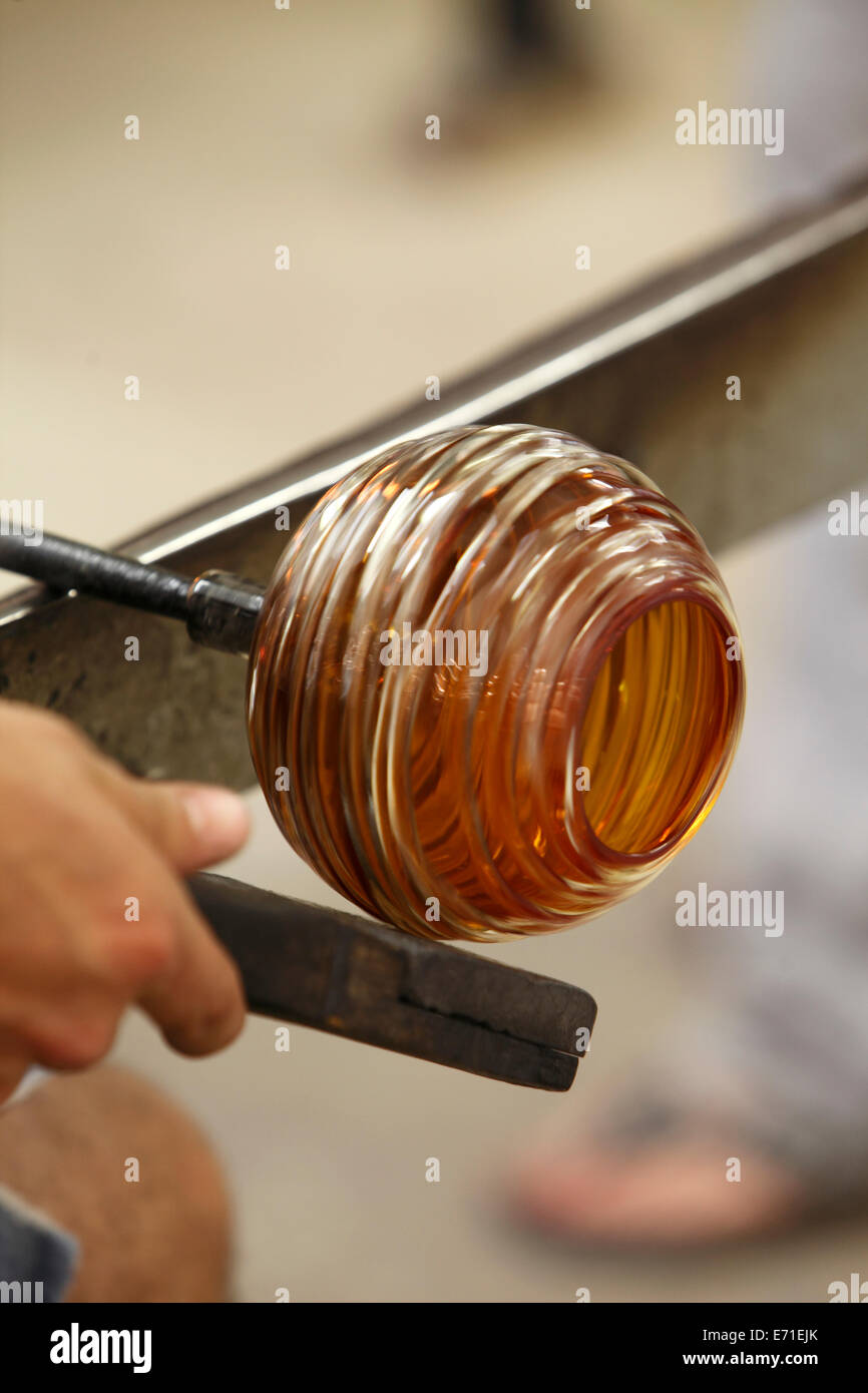 turning and shaping molten glass Stock Photo