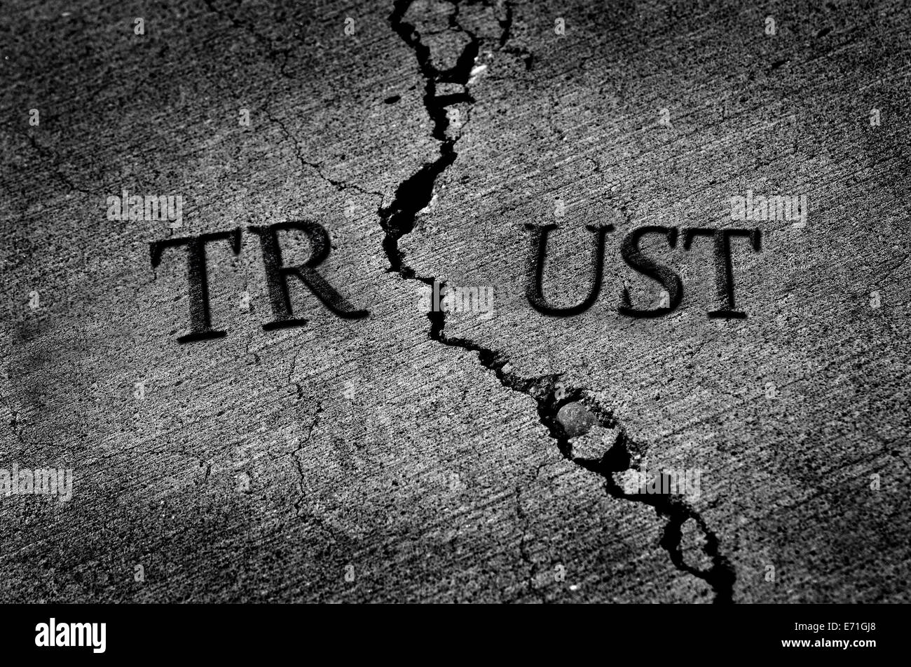 Cracked cement symbolizing broken trust between people or parties Stock Photo