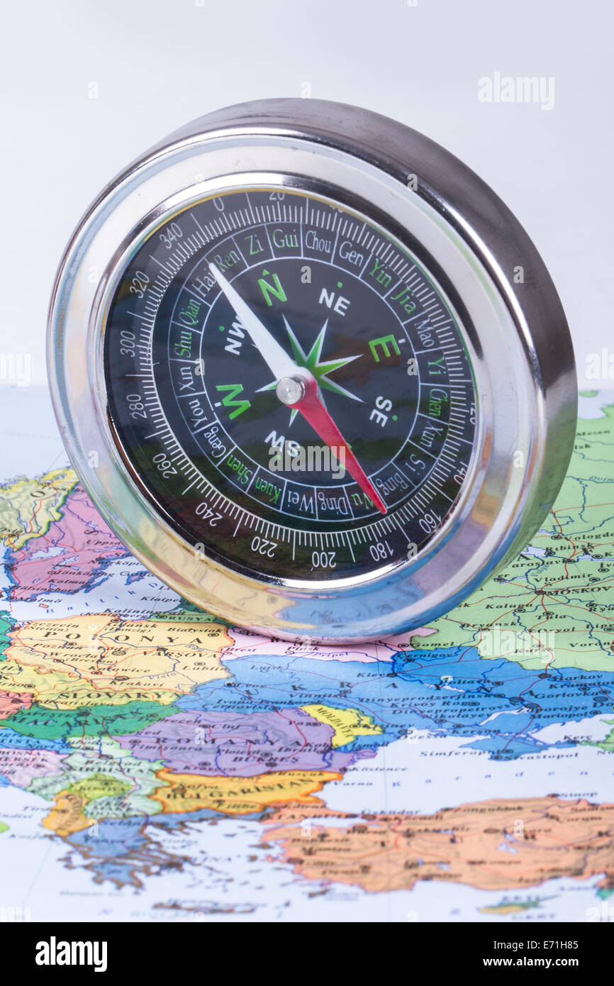 Compass on colorful map for your route Stock Photo Alamy