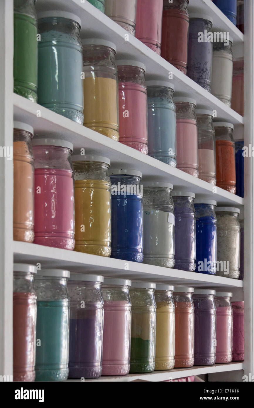 Shelving filled with rows of glass jars of colorful pigments in a apothecary or pharmacy in Marrakech, Morocco specialising in n Stock Photo
