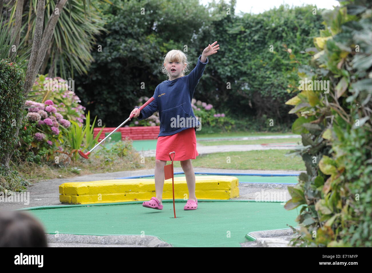 English children playing crazy golf in Newquay, Cornwall, Uk Stock