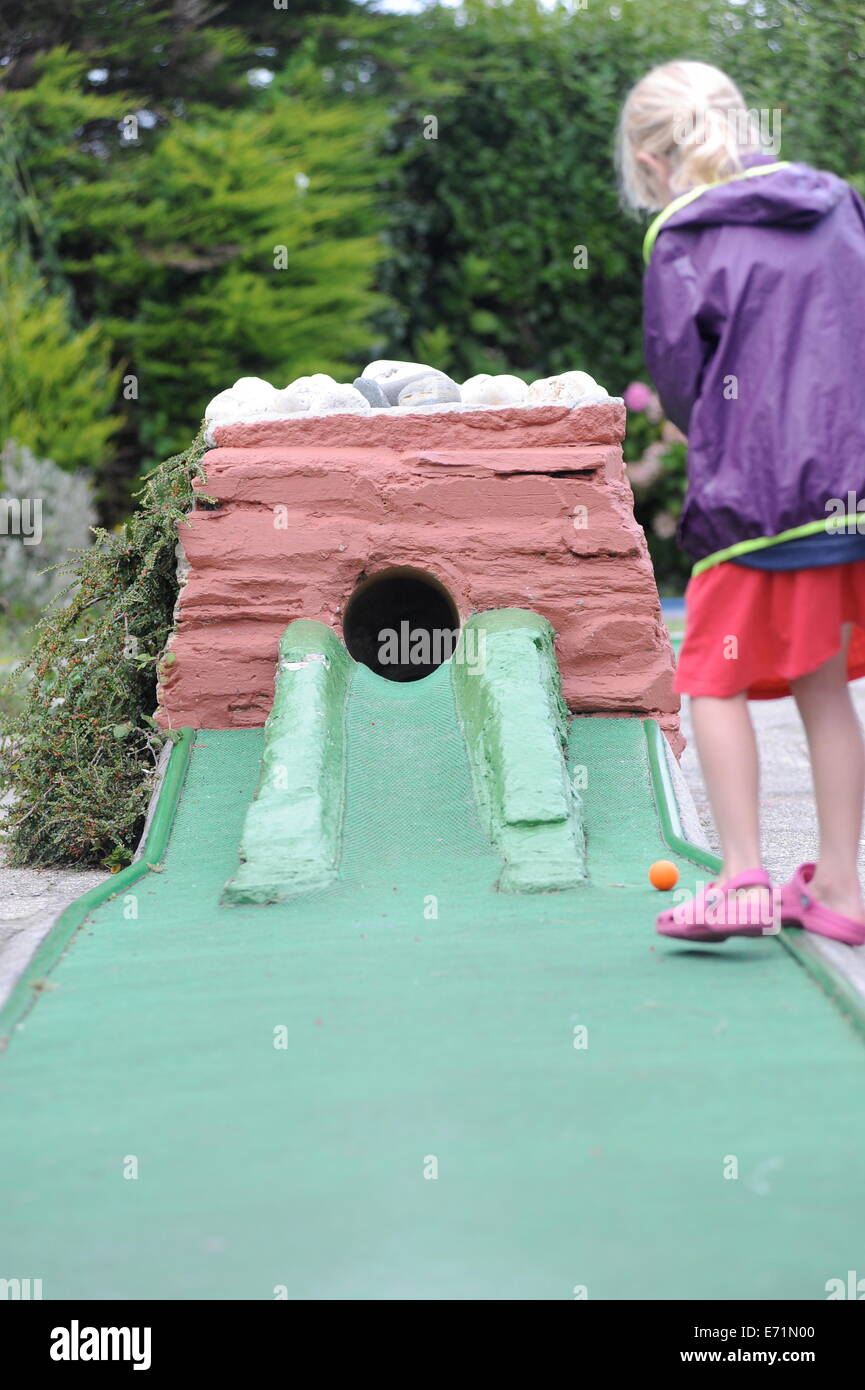 English children playing crazy golf in Newquay, Cornwall, Uk Stock