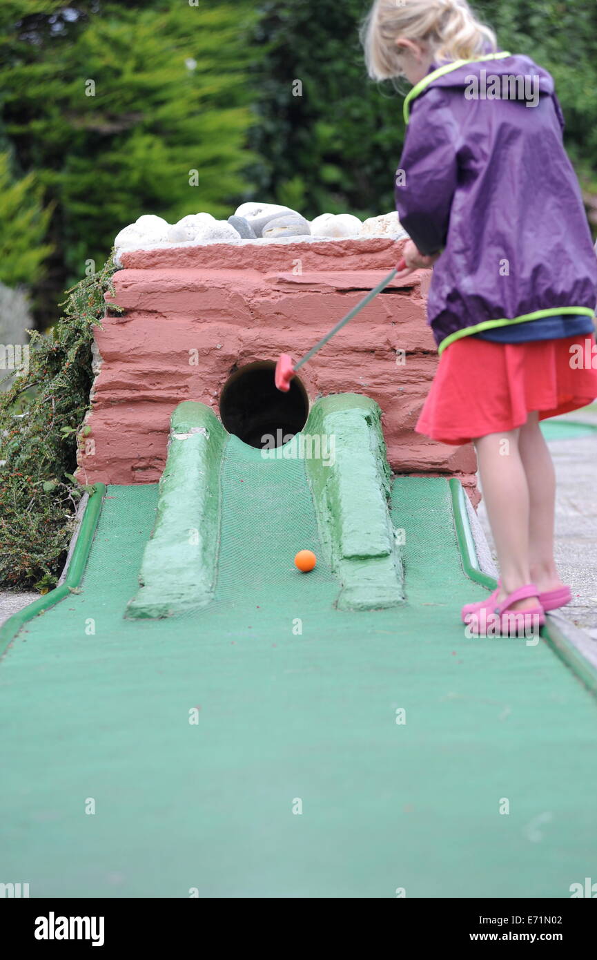 English children playing crazy golf in Newquay, Cornwall, Uk Stock