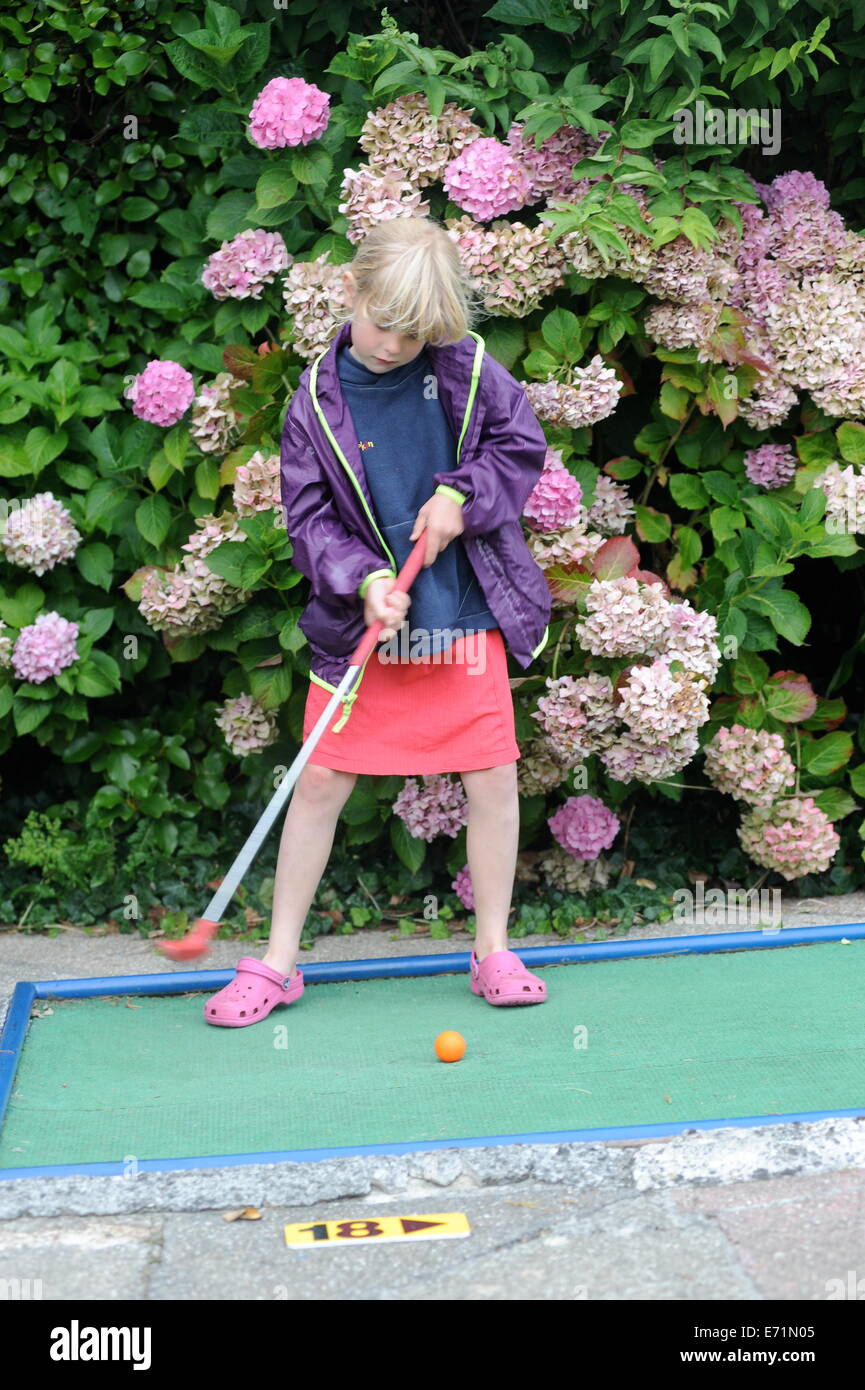English children playing crazy golf in Newquay, Cornwall, Uk Stock