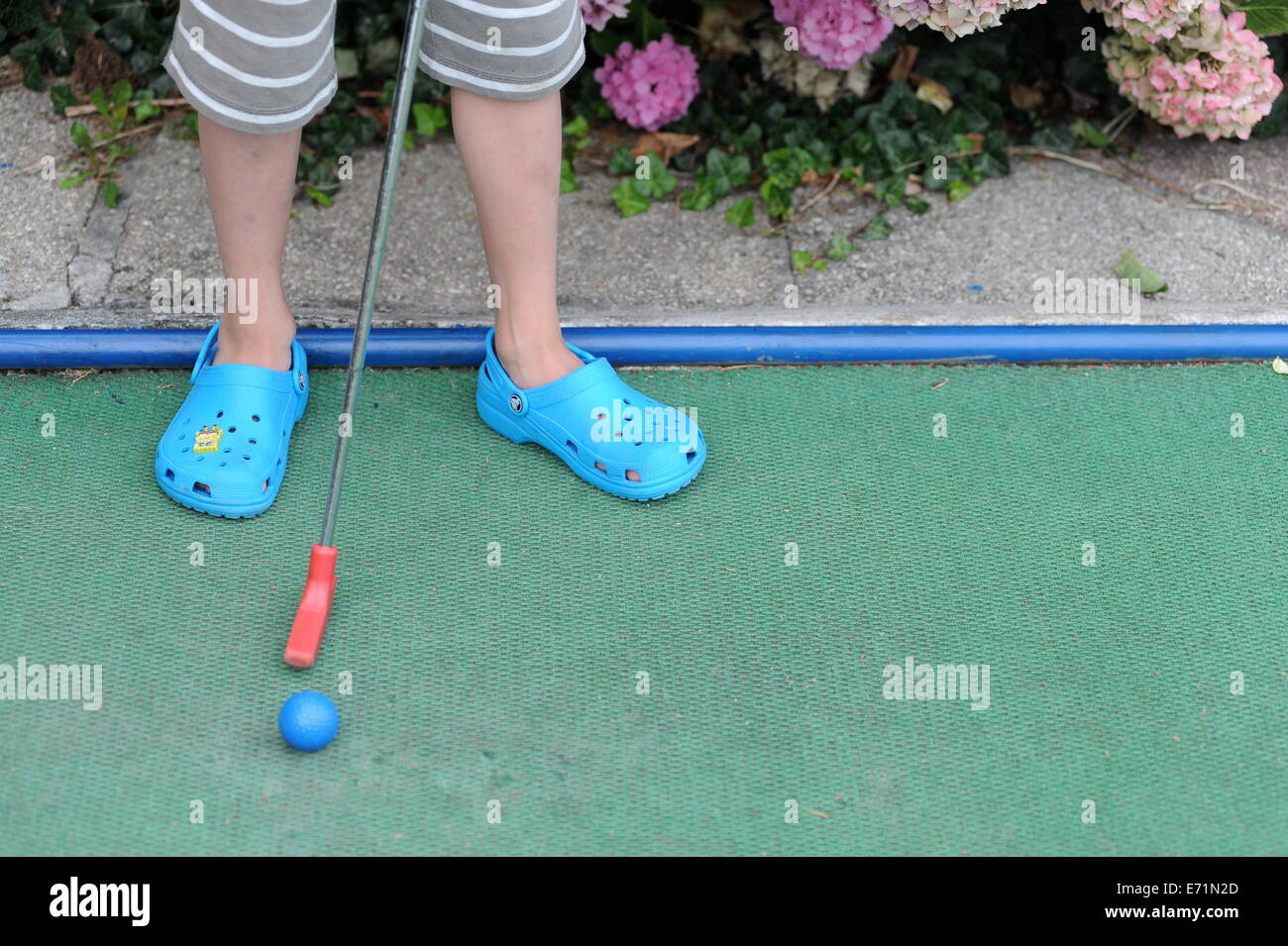English children playing crazy golf in Newquay, Cornwall, Uk Stock