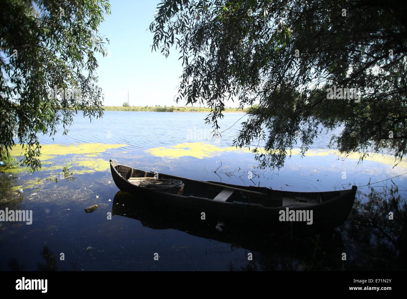 Color picture of a wooden boat on a river bank Stock Photo - Alamy
