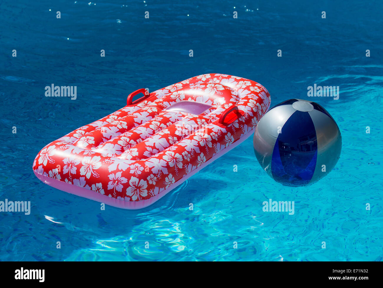 Airbed and Water Ball in Swimming Pool Stock Photo