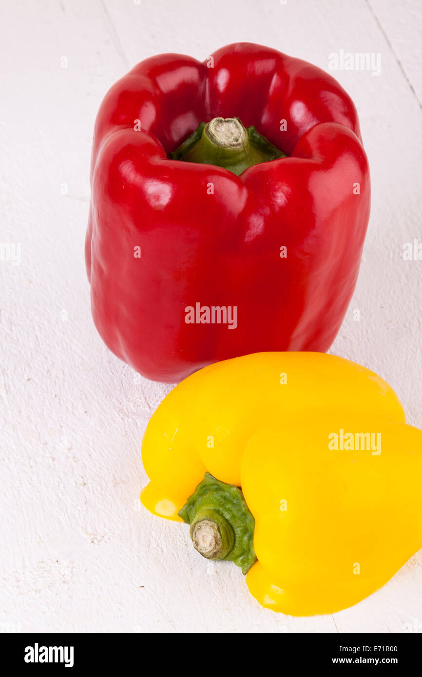 Red and Yellow Peppers on White Wooden Background Stock Photo - Alamy