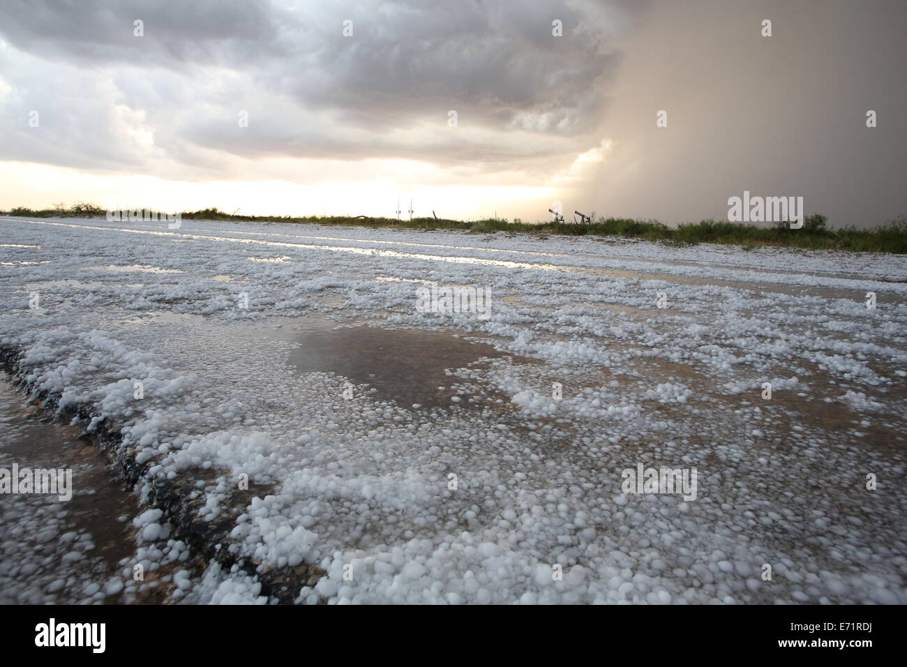 Hail covering a road after a storm near Carlsbad, New Mexico Stock Photo