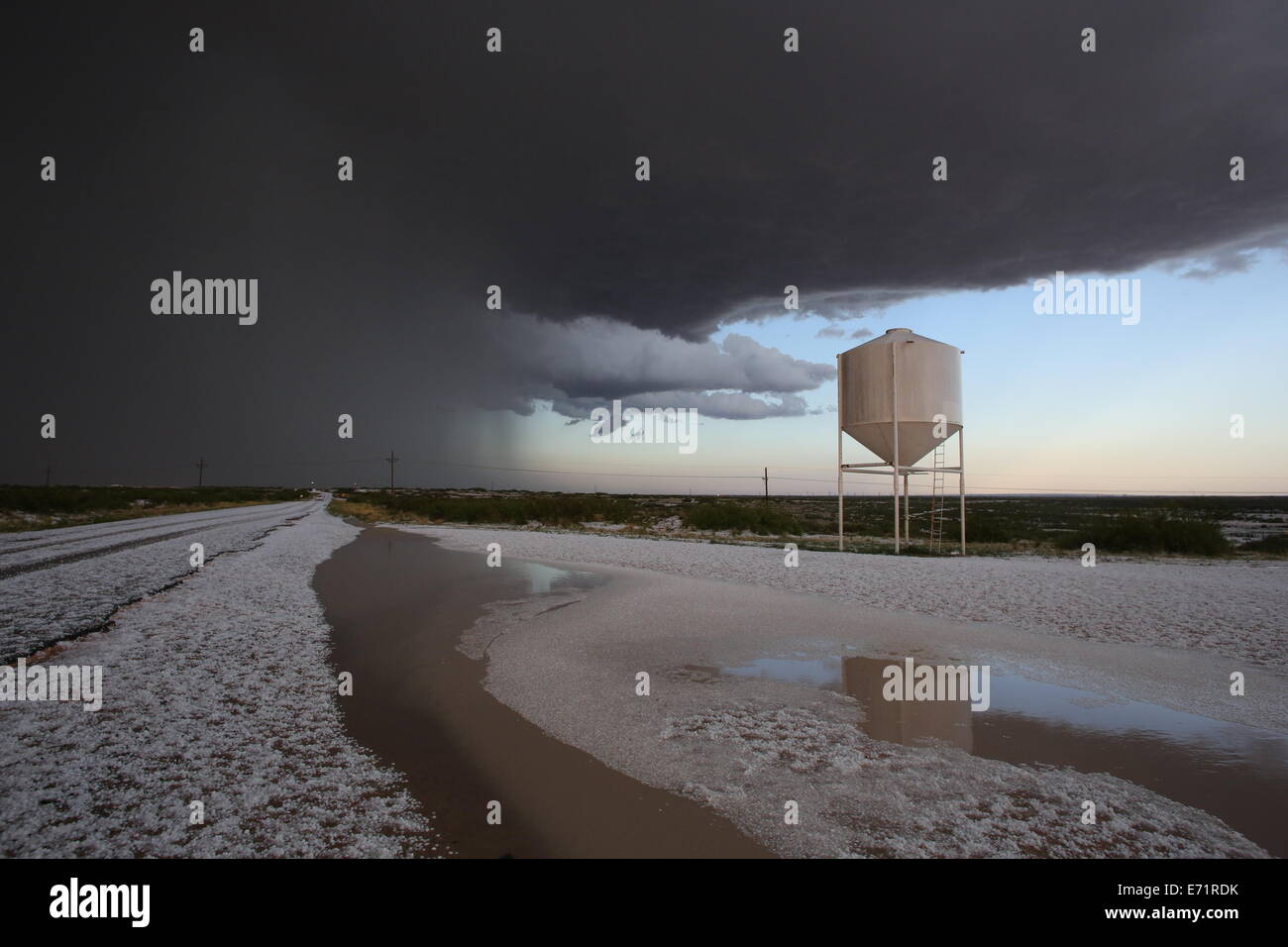 Hail on a road after a hail storm near Carlsbad, New Mexico. Stock Photo