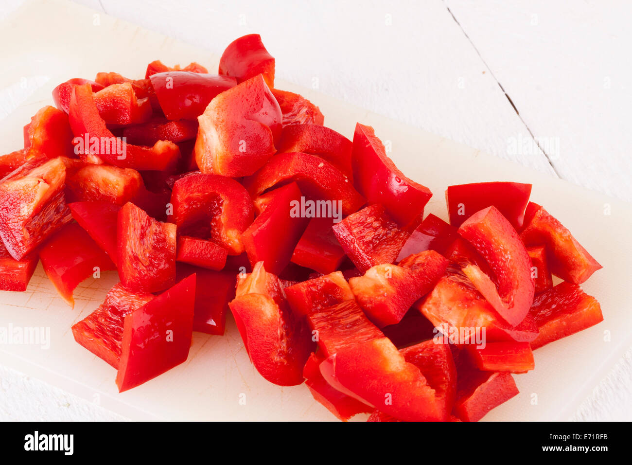 Red and Yellow Peppers on White Wooden Background Stock Photo - Alamy