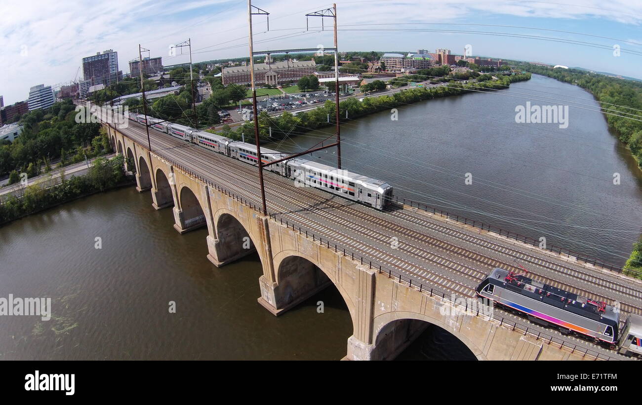 Aerial image of trains crossing the Northeast Corridor Railroad Bridge over the Raritan River in New Brunswick, New Jersey Stock Photo