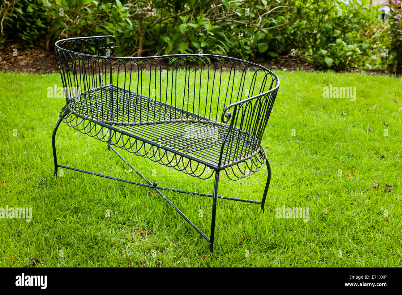 Metal loveseat on an English hotel lawn Stock Photo Alamy