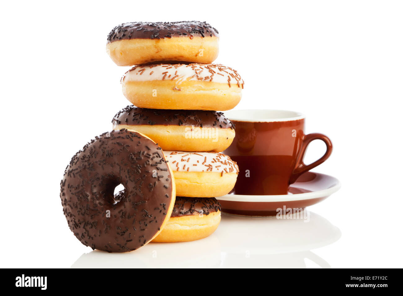 Stacked dark and white chocolate sprinkle donuts and coffee cup
