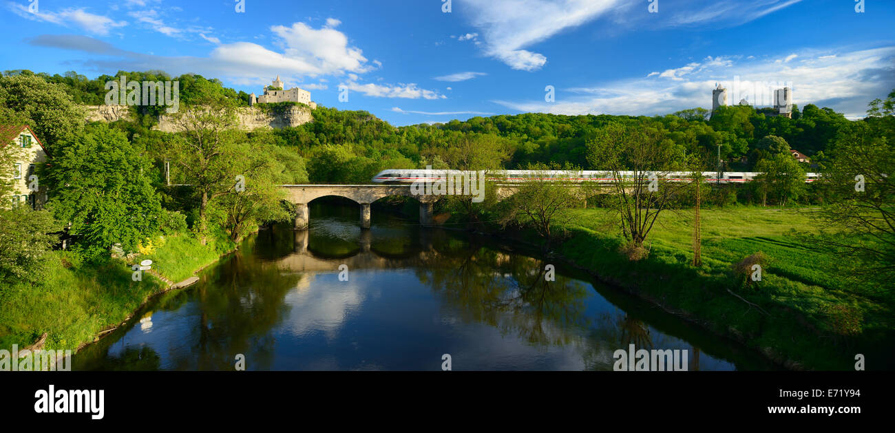 Ruins of Rudelsburg Castle and Burg Saaleck Castle on the Saale River with an ICE train crossing a railway bridge Stock Photo