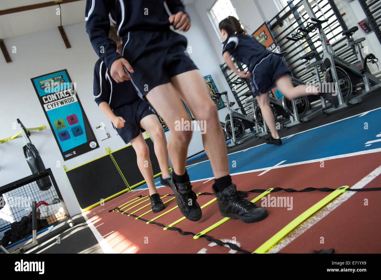Secondary education Wales UK school pupils in a gymnasium running on