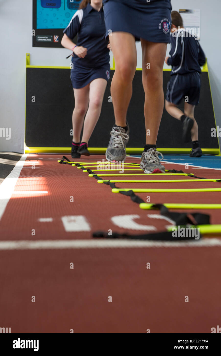 Secondary education Wales UK school pupils in a gymnasium running on