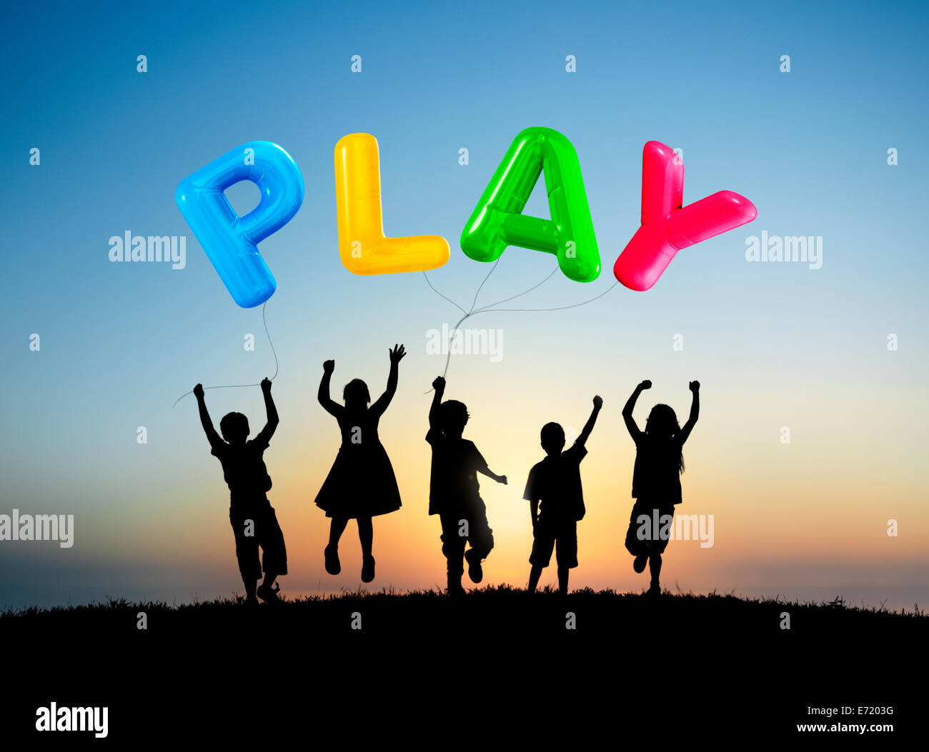 Silhouette of Children Playing Balloons Outdoors Stock Photo