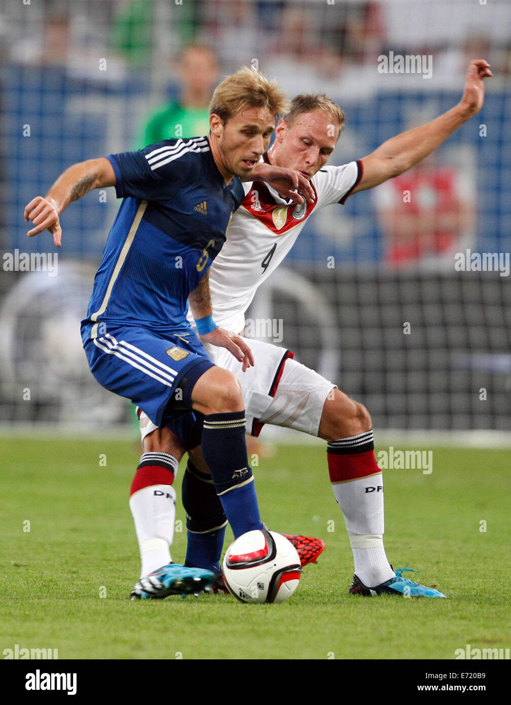 Duesseldorf, Germany. 03rd Sep, 2014. Germany's Benedikt Hoewedes (BACK) and Argentina's Lucas Biglia vie for the ball during international soccer match between Germany and Argentina at Esprit arena in Duesseldorf, Germany, 03 September 2014. Photo: Roland Weihrauch/dpa/Alamy Live News Stock Photo