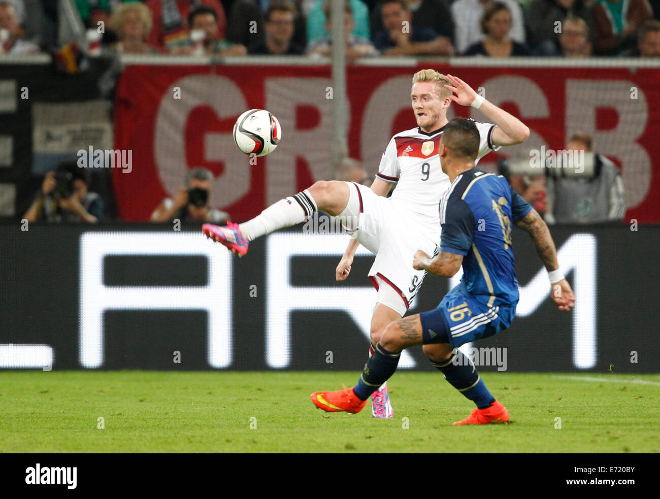 Duesseldorf, Germany. 03rd Sep, 2014. Germany's Andre Schuerrle (L) Argentina's Marcos Rojo vie for the ball during international soccer match between Germany and Argentina at Esprit arena in Duesseldorf, Germany, 03 September 2014. Photo: Roland Weihrauch/dpa/Alamy Live News Stock Photo