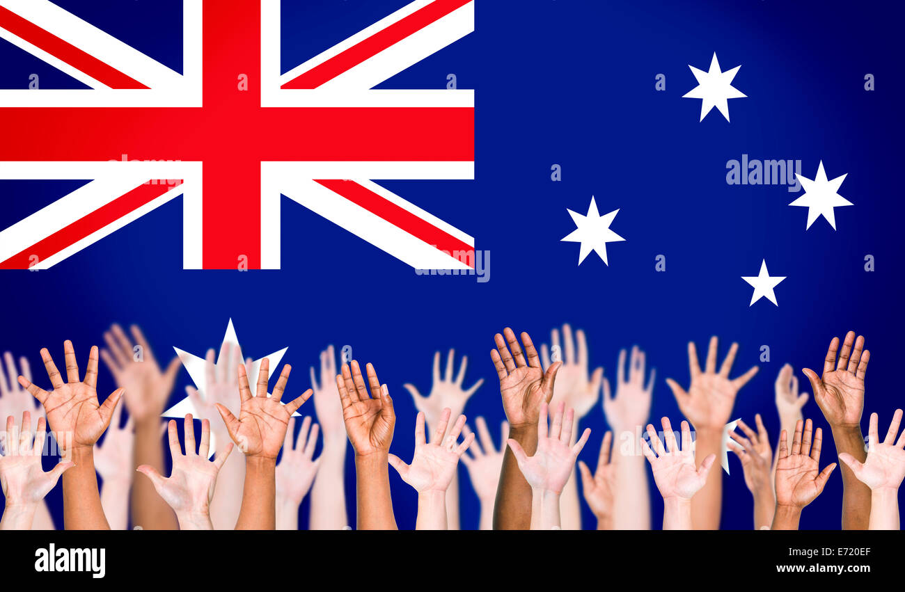 Multi-Ethnic Arms Raised and Australian Flag Background Stock Photo