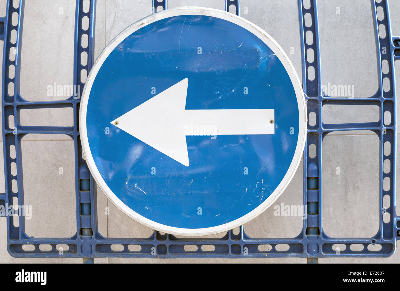 Blue road sign with white arrow to the left Stock Photo